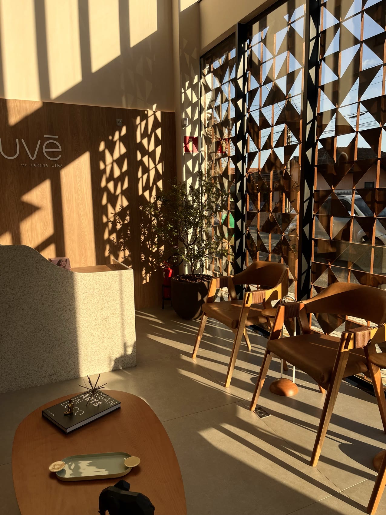 Lounge da Nuvê com painel muxarabi em luz dourada